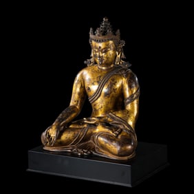 A Chinese Ming Dynasty gilt bronze statue of a seated Buddha