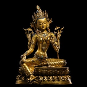 A Chinese Qing Dynasty gilt bronze statue of a seated Buddha