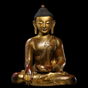 A Chinese Ming Dynasty gilt bronze statue of a seated Buddha