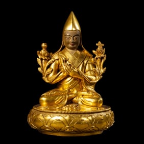 A Chinese Qing Dynasty gilt bronze statue of a seated Buddha