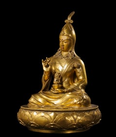 A Chinese Qing Dynasty gilt bronze statue of a seated Buddha