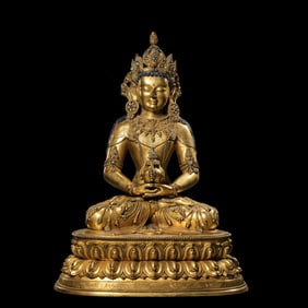 A Chinese Ming Dynasty gilt bronze statue of a seated Buddha