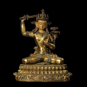 A Chinese Ming Dynasty gilt-bronze seated Buddha statue inlaid with gemstones