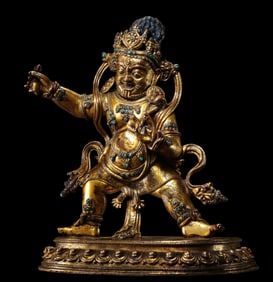 A Chinese Ming Dynasty gilt bronze statue of the God of Wealth inlaid with gemstones