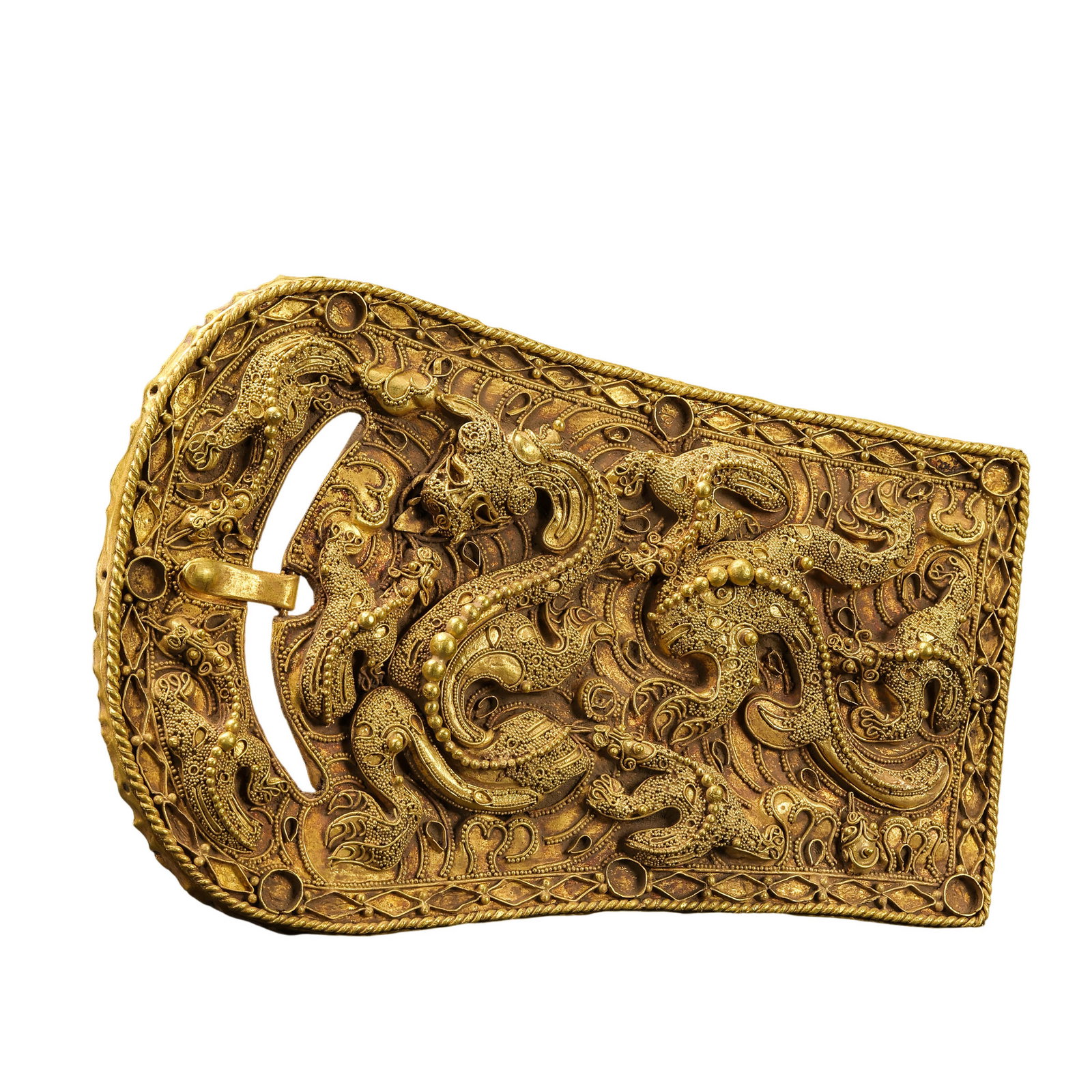 Warring States Period Solid Gold Belt Buckle, China: 5th–3rd century BCE; L. 11.5 cm. W. 7 cm. Weight 65.7 gram.Condition and Provenance?In good overall condition. The buckle appears structurally complete and is executed in gold, with the surface dens