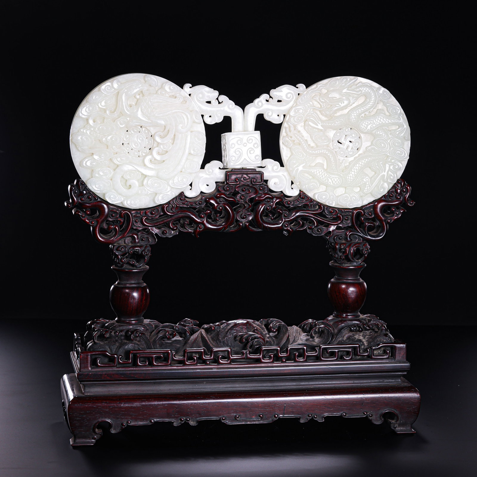 Qing Dynasty Hetian Jade Double Bi Disc Ornament with Dragon and Phoenix Decoration: 18th–19th century; width: 29 cm / 11.42 in; overall height with stand: 29.5 cm / 11.61 in; jade weight: 713 g / 25.15 ozCondition and Provenance?Condition: Overall in good condition. The two bi disc