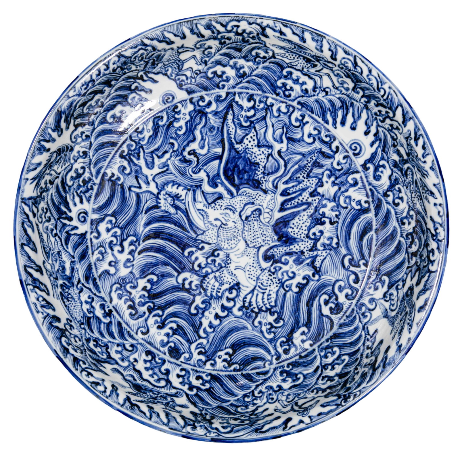 Chenghua Period, Ming Dynasty Blue and White Plate with Auspicious Beast amid Breaking Waves: 15th century; Diameter: 26 cm; approximately 10.24 in; approximately 0.85 ftCondition and Provenance?Condition: Overall well preserved, with a regular form, glossy glaze, and rich cobalt tones. Minor 