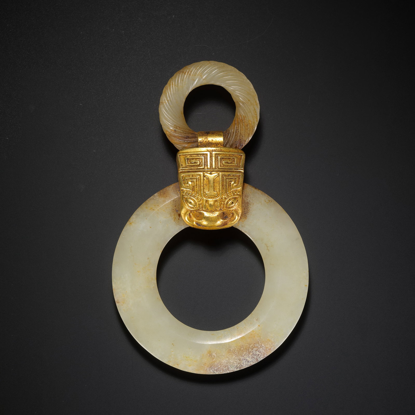 Warring States Period Hetian Jade and Gold-Inlaid Double-Ring Pendant with Taotie-Style Mask: 5th–3rd century BCE; Height: 10.5 cm, approximately 4.13 in, approximately 0.34 ft; Width: 6.5 cm, approximately 2.56 in, approximately 0.21 ft; Weight: 69 gCondition and Provenance?Condition: Overa