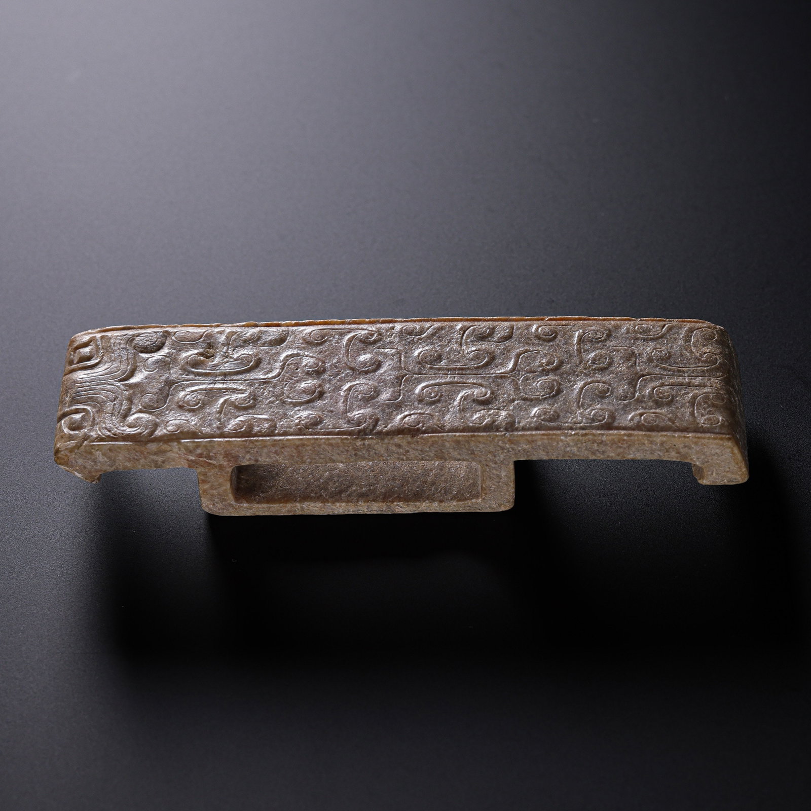 Warring States Period Hetian Jade Sword-Fitting-Style Ornament with Cloud-and-Thunder Decoration: 5th–3rd century BCE; Length: 9.5 cm, approximately 3.74 in, approximately 0.31 ft; Height: 2.5 cm, approximately 0.98 in, approximately 0.08 ft; Weight: 47 gCondition and Provenance?Condition: Overa