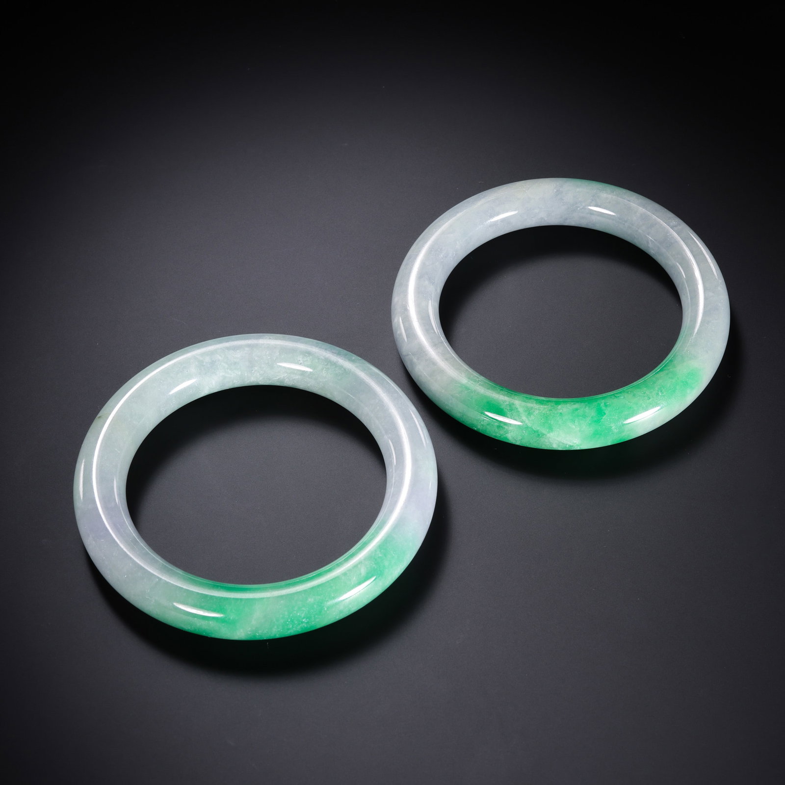 Qing Dynasty (18th–19th century) Pair of Jadeite Bangles: Diameter: approx. 8 cm (3.15 in; 0.26 ft); Total weight: 170 gCondition & Provenance?Condition: Overall in good condition. The jadeite is finely textured and well-polished, with natural color patches 