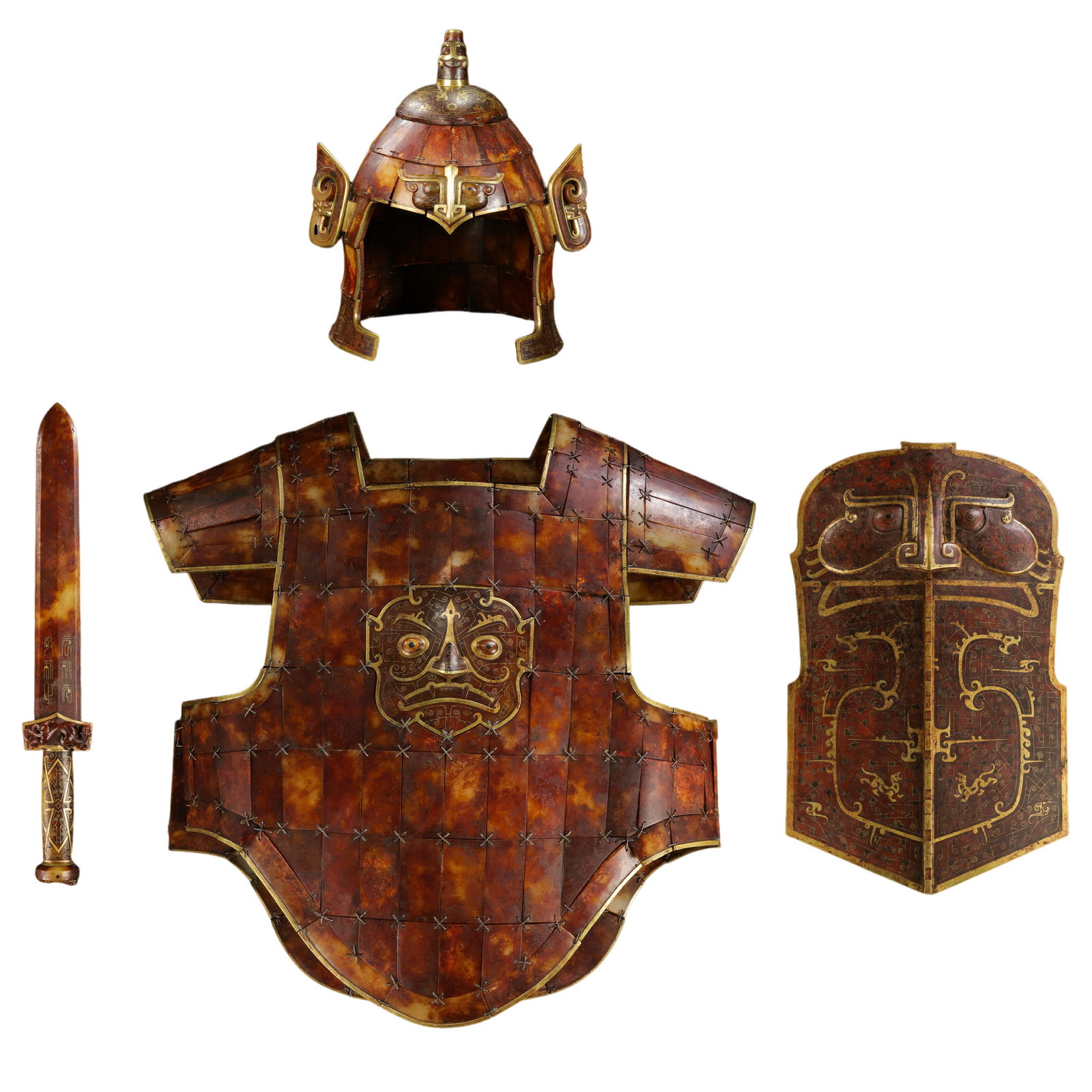 Warring States Period Hetian Jade Armor, Helmet, Sword, and Shield Set with Gold-Inlaid Mask Designs: 5th–3rd Century BCE; Helmet: H. 37 cm, W. 31 cm, weight 5144 g; Sword: L. 51 cm, W. 7.5 cm, weight 848 g; Armor: L. 60.5 cm, W. 64 cm, weight 11.6 kg; Shield: L. 41.5 cm, W. 26.5 cm, weight 4055 g; 