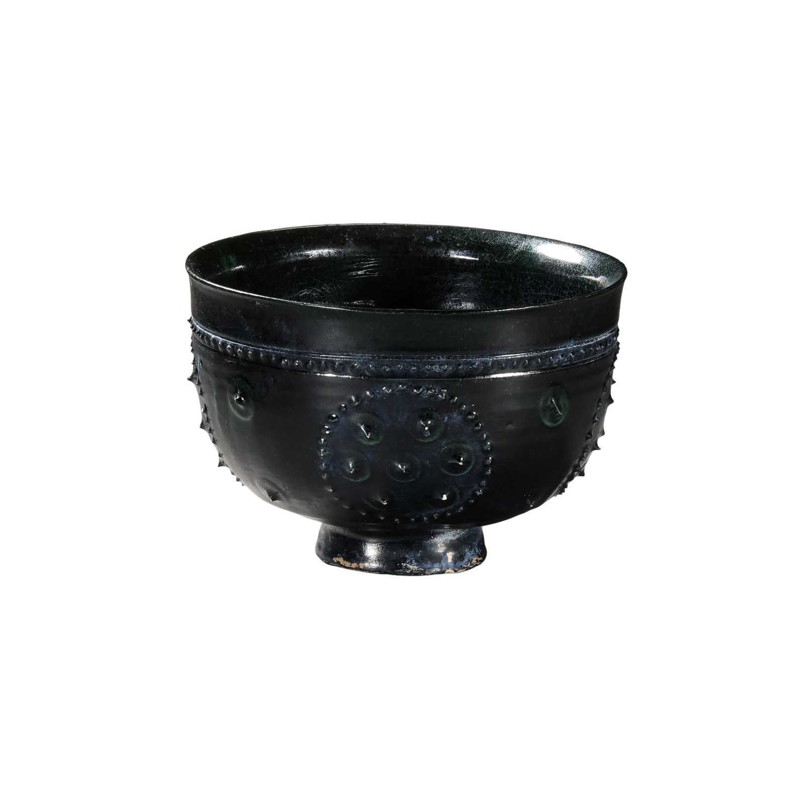 Tang Dynasty Sancai Black-Glazed Stem Bowl with Applied Bead Decoration: 7th–10th Century; H. 7 cm, Diam. 10.2 cm; H. approx. 2.76 in, Diam. approx. 4.02 inCondition and Provenance: Good condition, with the overall form intact, lustrous dark glaze, natural crackling, sur