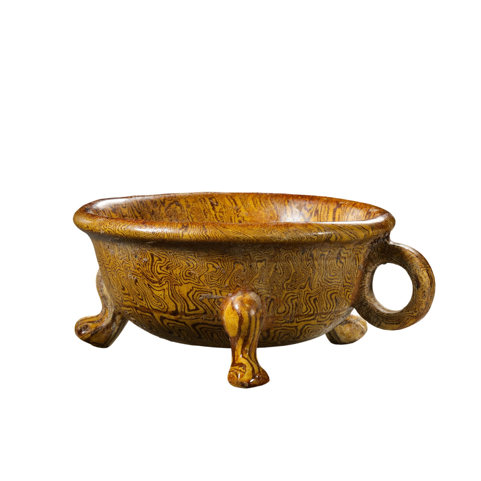 Tang Dynasty Marbled-Glaze Tripod Cup with Ring Handle: 7th–10th Century; H. 4.5 cm, L. 9.3 cm; H. approx. 1.77 in, L. approx. 3.66 inCondition and Provenance: Good condition, with the overall form intact, warm lustrous glaze, natural crackling, firing t