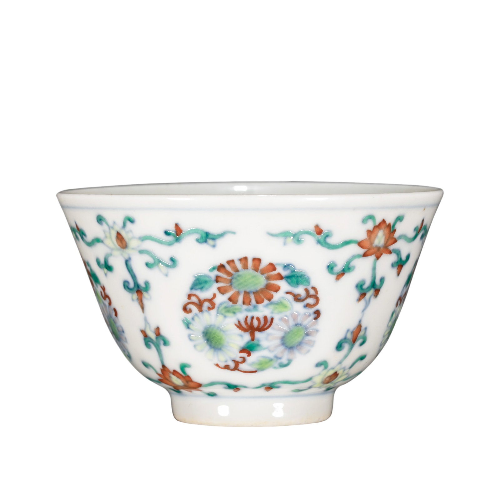 Yongzheng Period, Qing Dynasty Doucai Cup with Floral Scroll Design: 18th Century; H. 4.5 cm, Diam. 7 cm; H. approx. 1.77 in, Diam. approx. 2.76 inCondition and Provenance: Good condition, with the overall form intact, lustrous glaze, elegant doucai enamels, minor firi