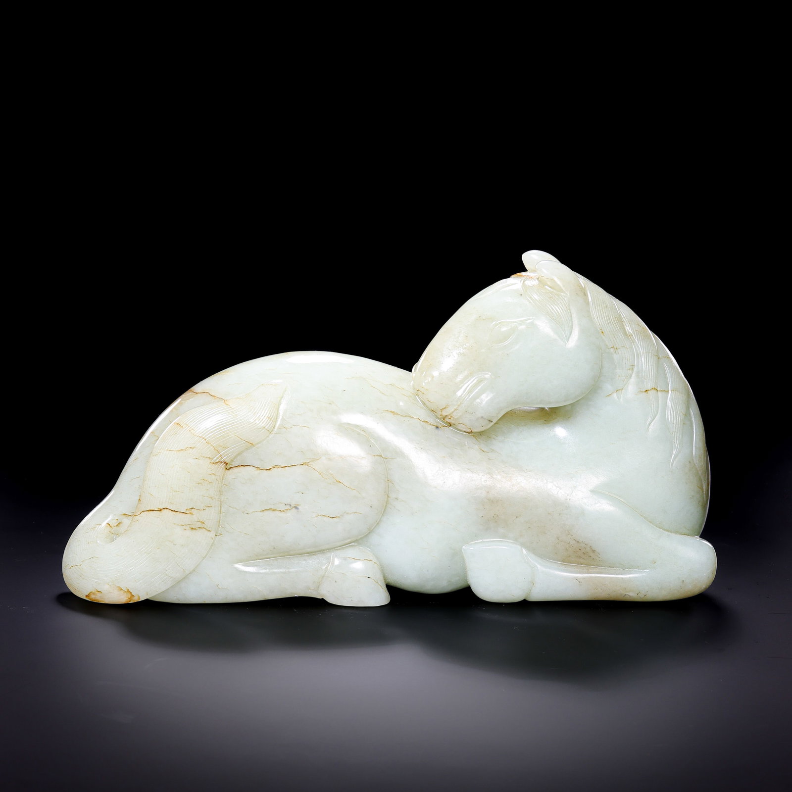 A Hetian Jade Recumbent Horse, Qing Dynasty: approx. 16 cm (6.3 in), Height: approx. 14 cm (5.5 in), Weight: approx. 3,017 g, 18th–19th CenturyCondition & Provenance:?In good condition overall. The jade is smooth and softly lustrous, with natu