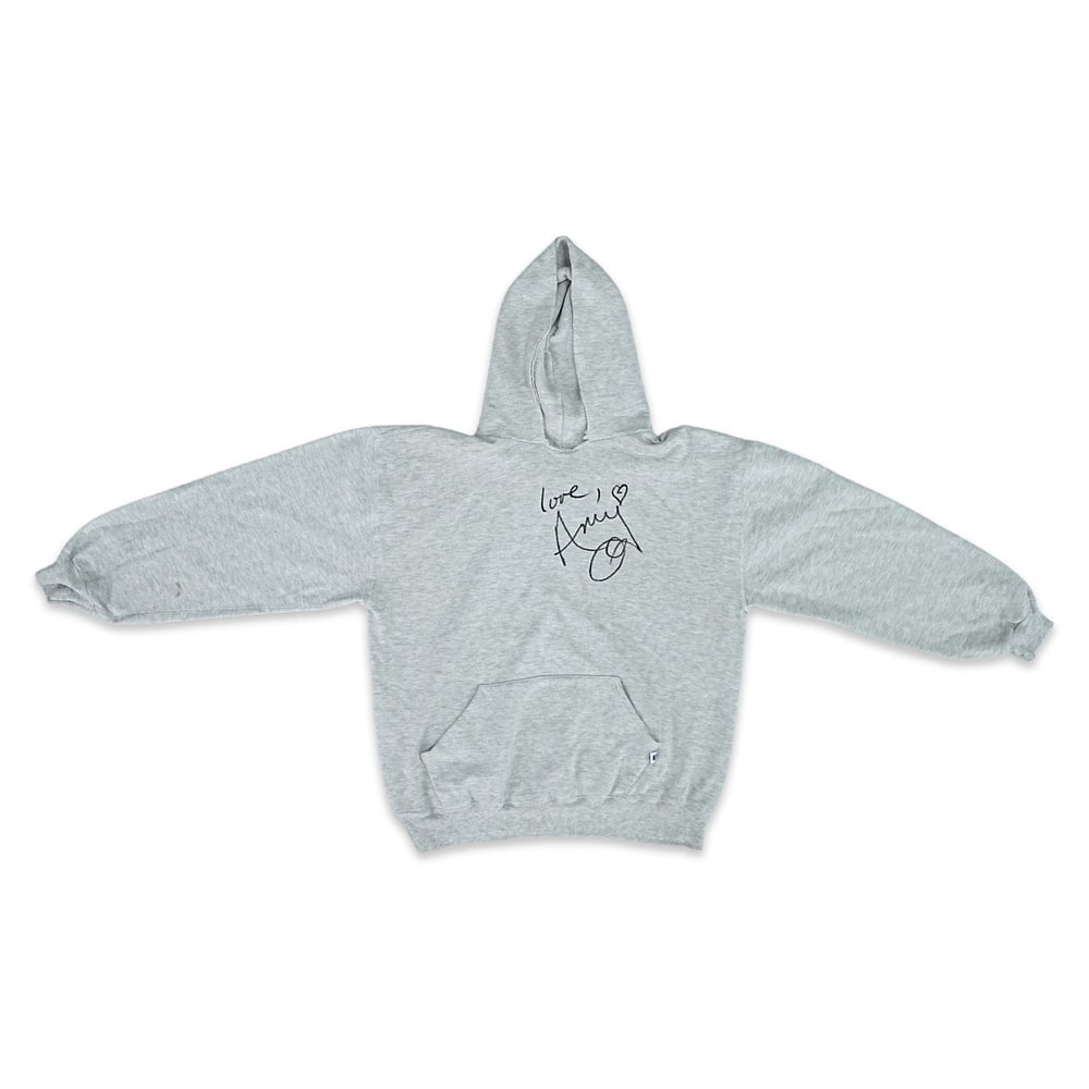 AMY WINEHOUSE SIGNED RUSSELL ATHLETIC HOODED SWEATSHIRT: Size L; Length: 24 3/4 in (63 cm); Sleeve: 21 5/8 in (55 cm); Shoulder: 23 1/4 in (59 cm) Provenance and Authentication: According to the accompanying documentation provided by the consignor, the