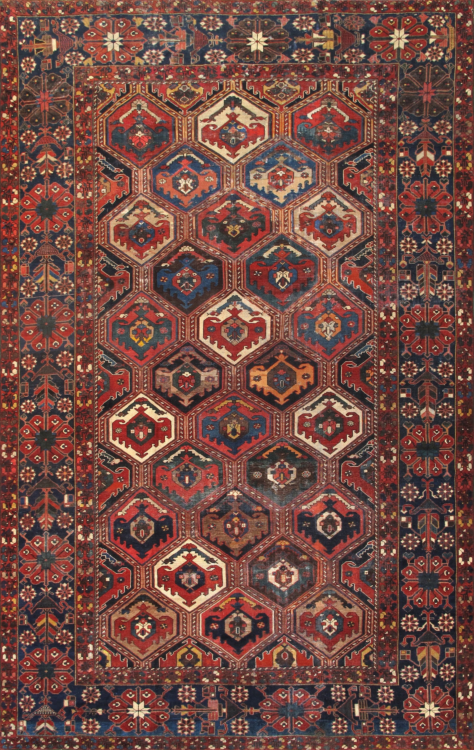 Antique Bakhtiari Carpet, Southwest Persia, 10'11'' X 17' 0'': Measuring approximately 10 ft. 11 in. x 17 ft., this distinguished Bakhtiari carpet is handknotted in fine lamb’s wool. The richly colored field, rendered in deep navy with a vibrant array of po
