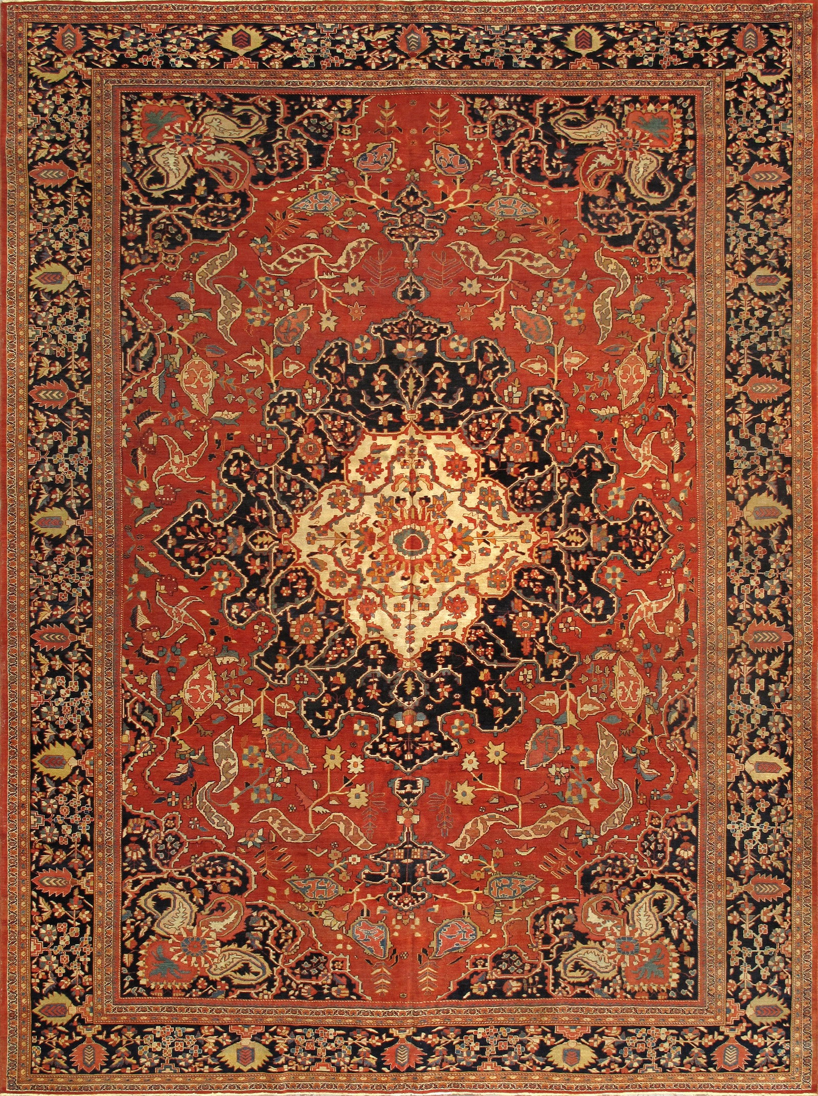 Antique Ferehan Carpet, West Persia, 10'11'' X 14' 9'': The rich madder-red field centered by a bold, intricately serrated medallion in rust and navy, surrounded by an elegant network of stylized leaves, palmettes, and delicate vinery. The spacious drawing