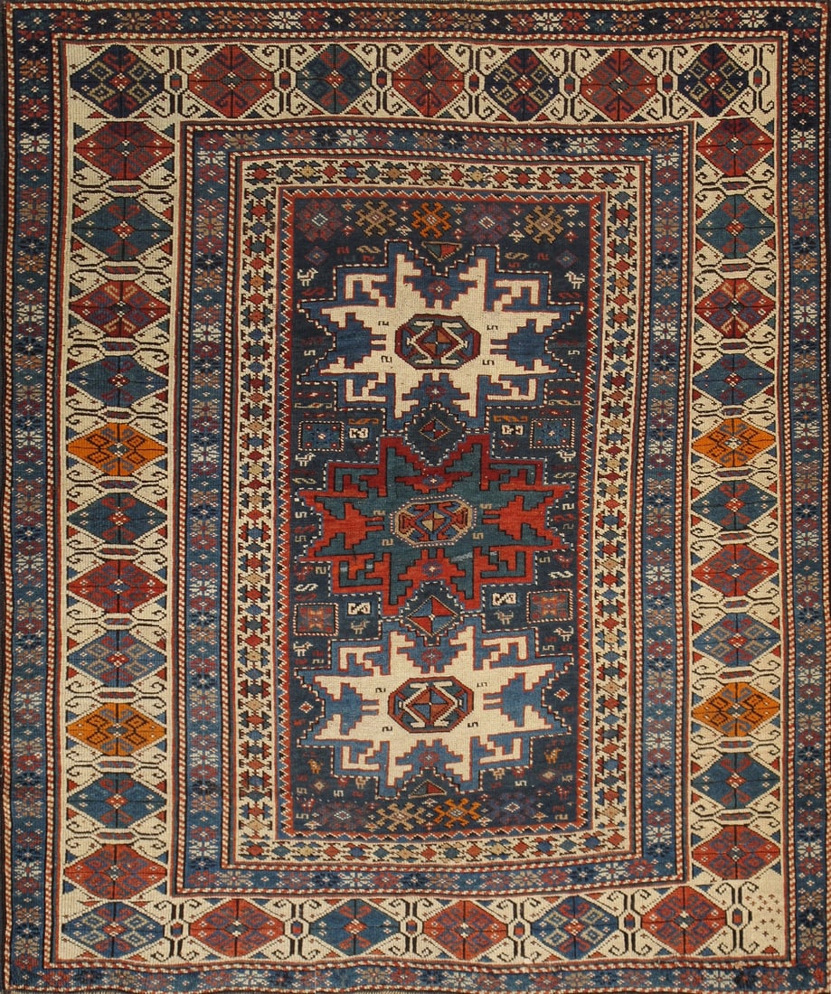 Antique Caucasian Kazak Hand-Knotted Wool Rug – Geometric Tribal Design: Discover the timeless artistry of this Antique Azerbaijani Caucasian rug, a remarkable hand-knotted masterpiece celebrated for its bold geometric medallions, intricate tribal motifs, and richly detail