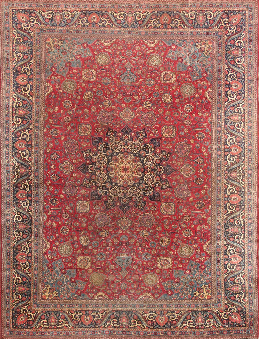 Antique Dabir Kashan Carpet, West Persia, 10' 5'' X 13' 6'': The richly saturated madder-red field centers a finely drawn medallion surrounded by an intricate network of scrolling vines, palmettes, and delicate floral sprays. The dense and balanced composition 