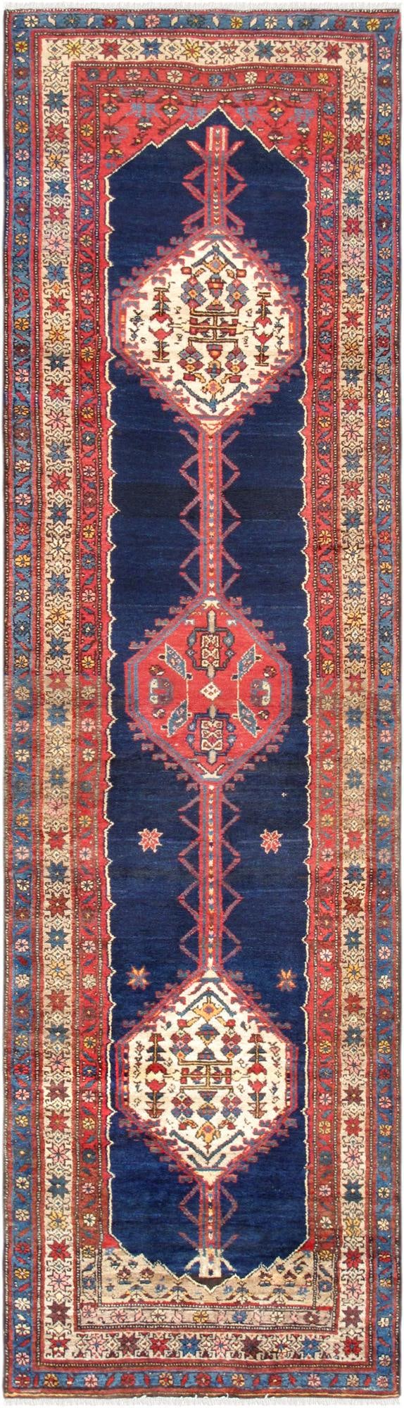 Vintage Northwest Persian Runner 3.01x11.05: A beautiful vintage Northwest Persian runner showcasing the timeless artistry of Persian tribal weaving. This exceptional piece features a rich deep indigo field accented by bold ruby red and ivory ge