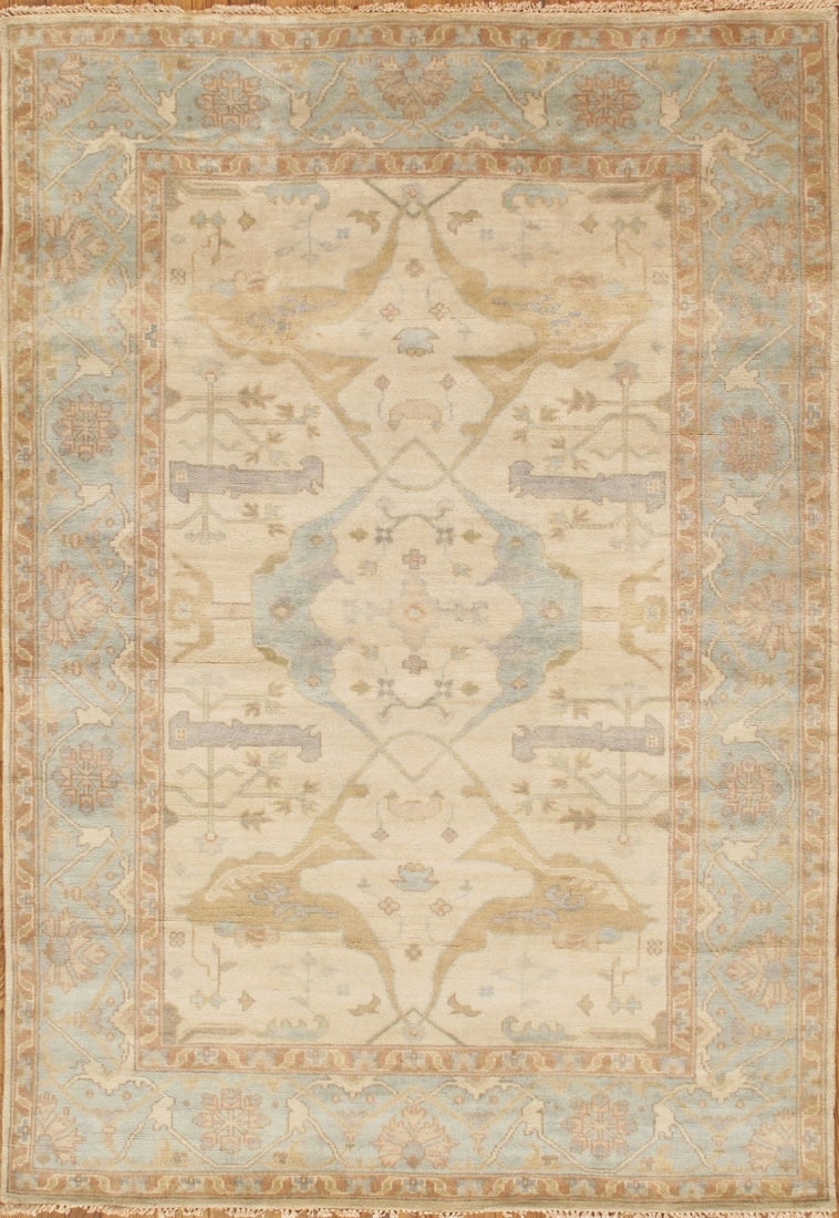 Oushak Hand-Knotted Wool Area Rug, Ivory/L. Blue- 4' 4'' X 6' 1'': The Oushak Collection reflects the enduring character of traditional hand-knotting, defined by its floral motifs and softened, tonal palette. Each rug is hand-knotted from hand-spun lamb’s wool, res