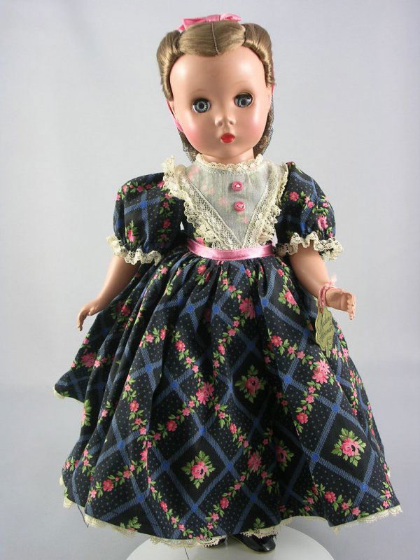 14" LITTLE WOMEN "BETH" BY ALEXANDER: Five-piece hard plastic body, Maggie face, sleep eyes, light brown floss wig, tagged dress. Includes clover wrist tag. Circa 1948-49.