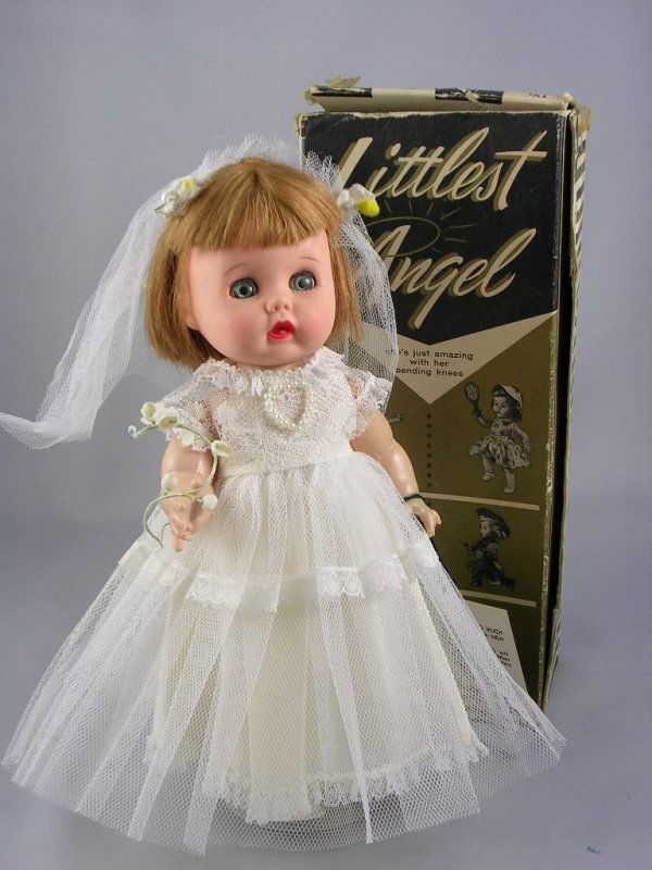 11" LITTLEST ANGEL BRIDE IN BOX: Seven-piece hard plastic walker body, vinyl head, light brown wig. Wearing June Bride. Includes wrist tag. In box.