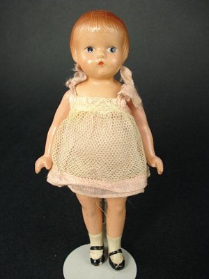 6" COMPOSITION WEE PATSY BY EFFANBEE: Marks: Effanbee//Wee Patsy on back. Five-piece body, painted eyes, molded and painted hair. Wearing original white net over pink organdy sundress with attached onesie, painted socks and shoes. Some fl