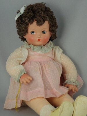 16" COMPOSITION AND CLOTH "SISTER" BY EFFANBEE: Composition head, painted eyes, closed mouth, yarn hair. Cloth body with composition hands. Original dotted Swiss dress over onesie and matching panties, socks and leatherette shoes. 1943. Gorgeous co