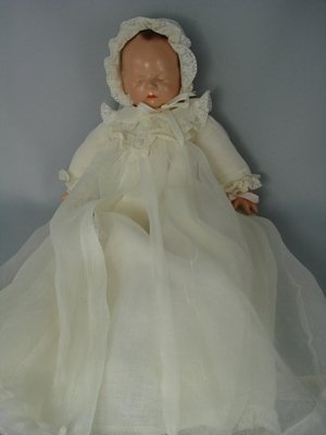 12" COMPOSITION AND CLOTH BABYETTE BY EFFANBEE: Marks: C//Effanbee//Babyette on head. Composition flange head with painted (sleeping) eyes and painted hair. Cloth baby body with composition gauntlet hands. Wearing all original organza baby gown wit