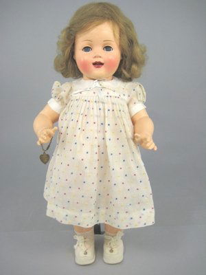 18" RAYNAL FRANCE CELLULOID TODDLER W/FLIRTY EYES: All celluloid doll marked Raynal (in a box) on back of shoulders and head. Flirty sleep eyes with hair lashes, open mouth with 2 teeth, original human hair wig. Vintage, possibly original dress, brass