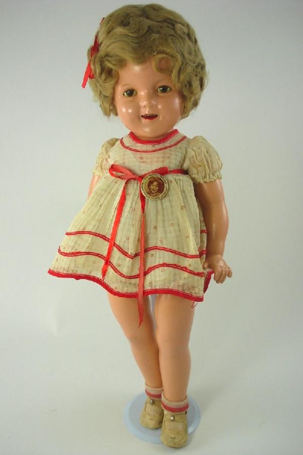 22" COMPOSITION SHIRLEY TEMPLE BY IDEAL: Marked as shown on head and back. All composition with sleep eyes, real upper lashes, open mouth with teeth and tongue, soft mohair wig. Five-piece strung body. Untagged but all original clothing - dr