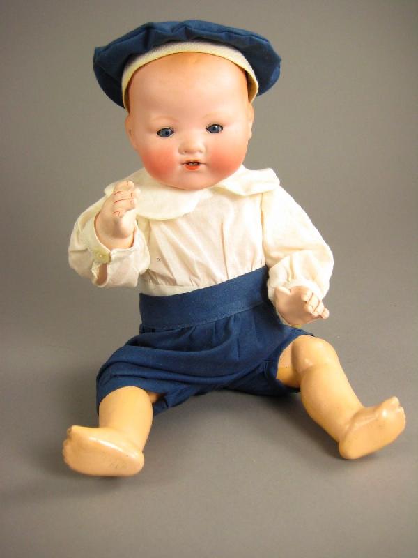 13" A. M. 351 INFANT COMPOSITION BODY: Solid dome bisque head has blue sleep eyes, open mouth and painted hair. Five piece bent limb composition baby, nicely redressed. eye chip, arm's are repainted and color of legs don't match torso. Cir