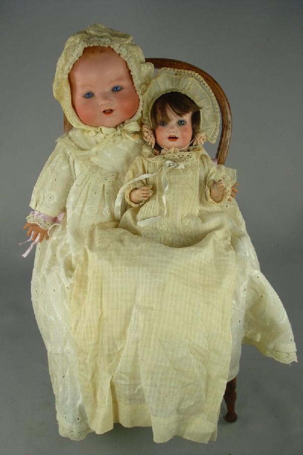 TWO ARMAND MARSEILLE BISQUE HEAD DOLLS: 1.) 10" AM 971 marked as shown on bisque socket head. Blue sleep eyes, open mouth with 2 upper teeth, human hair wig. Composition bent-limb baby body with original finish. Vintage clothing. Some repai