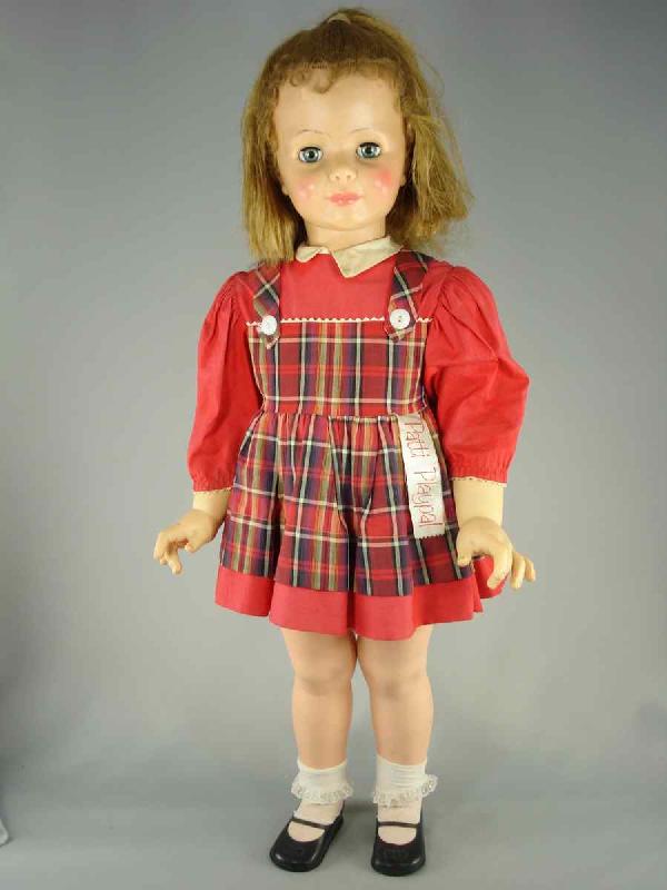 35" PATTI PLAYPAL IN TAGGED DRESS: Marks: Ideal Doll//35 on head; no marks on back. Sleep eyes, dark blonde rooted hair with spit curls. Five-piece hard plastic body. Wearing tagged dress, matching panties, likely original shoes. This