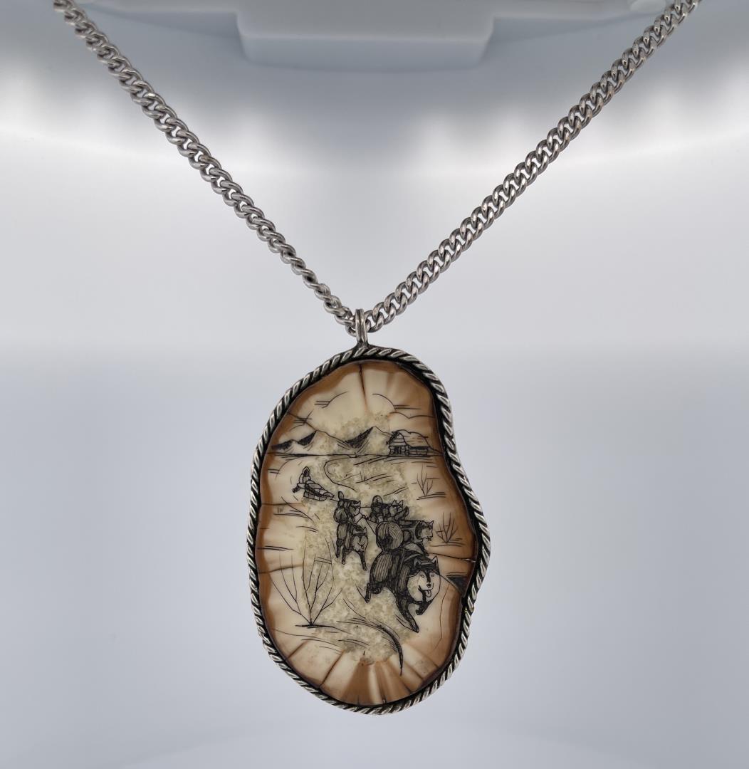 Alaskan Inuit Eskimo Scrimshaw Necklace: Scrimshaw of a dog sled team on fossil mammoth tusk. Allard Auction Collection Inv: 49646 SUZ