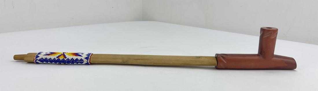 Carved Native American Indian Pipestone Pipe: Very finely made with beaded stem. 23.75" long. Pipe stem made by Hollow Horn Bear.