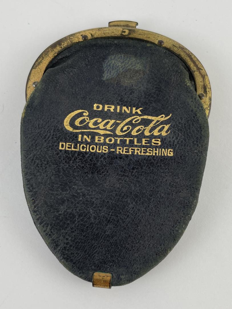 1910 Coca Cola Double Coin Change Purse: Antique leather Coca Cola double change purse. Interior of the purse has a compartment on each side. Shows some wear to the leather and corrosion to the brass. Good condition, overall.