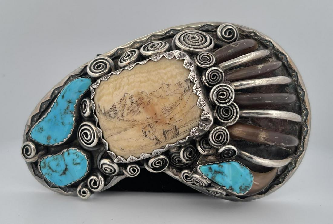 Navajo Bear Claw Sterling Turquoise Belt Buckle: Stunning buckle. Scrimshaw center panel, surrounded by turquoise and black bear claws. Signed as shown. 4 1/2" long. Only for sale where legal. No International Sales. Know your own laws. No sales to 
