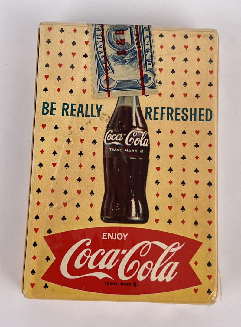Vintage 1961 Coca-Cola Playing Cards: 1961 deck of Coca-Cola playing cards featuring a "Card Game" theme. The deck being offered here is Mint Sealed in the original box, as issued. This deck was not issued with cellophane. The box is in g