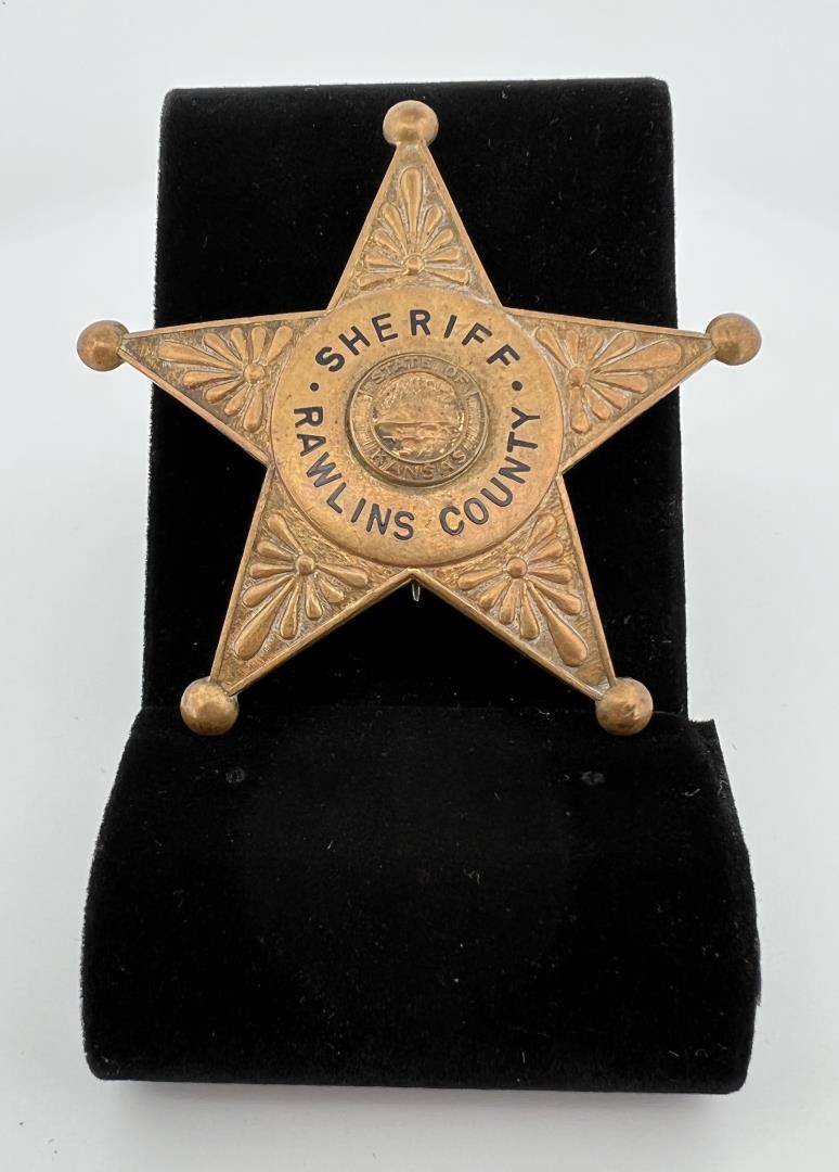 Sheriff Rawlins County Kansas Badge: 2 1/2" diameter. Provenance: Jack Ooley Collection.