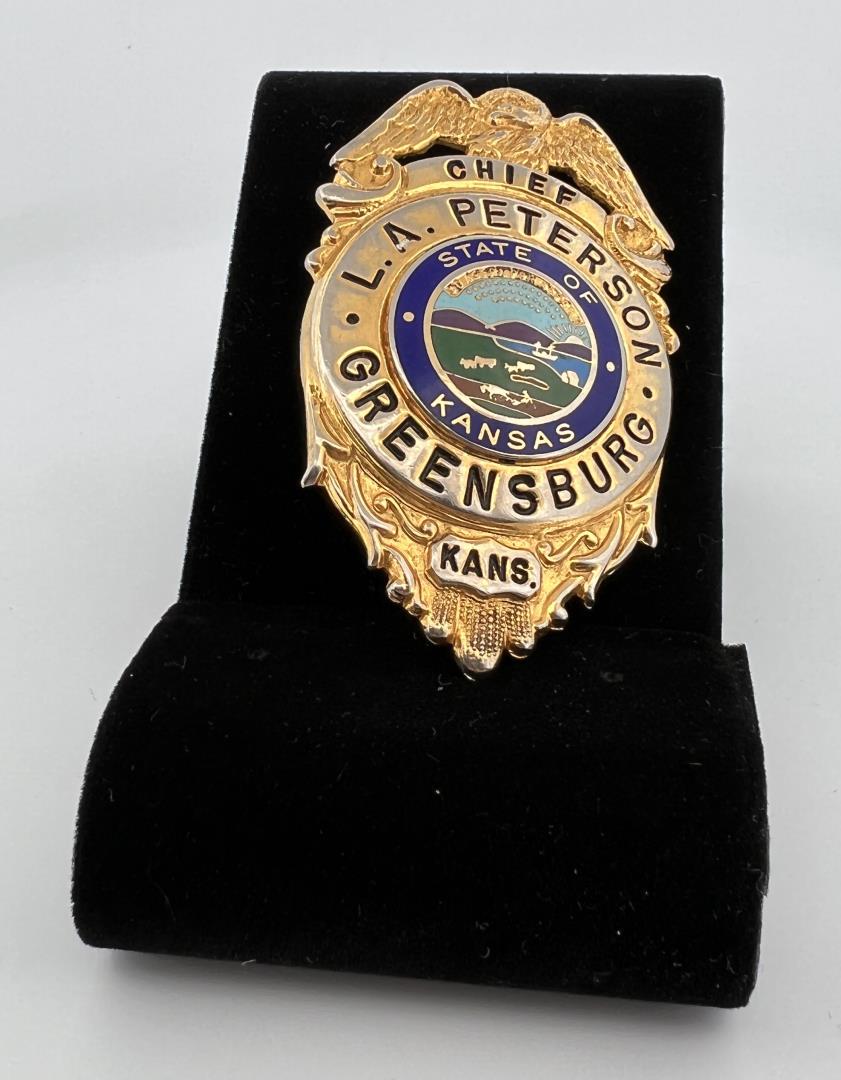 Chief of Police Greensburg Kansas Badge: Named to L.A. Peterson. 2 1/2" long. Provenance: Jack Ooley Collection.