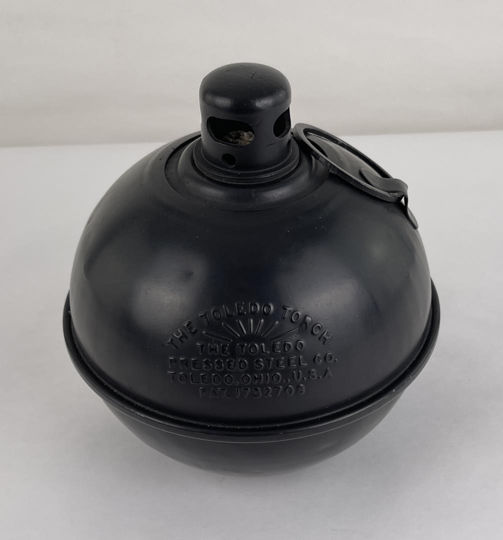 The Toledo Torch Road Flare: 7 3/8" in diameter, 7 3/4" tall. Appears to be unused.