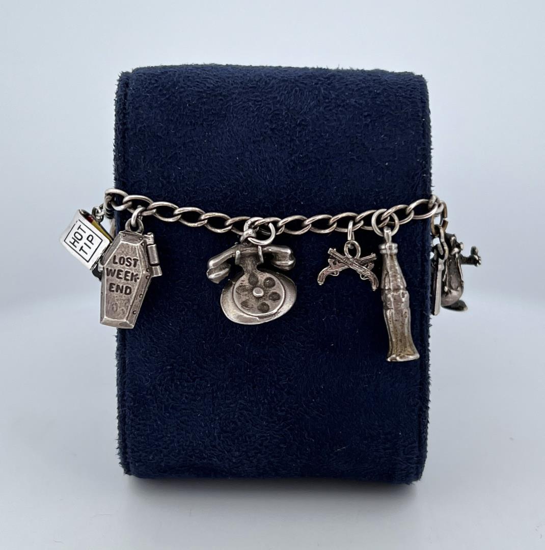 Sterling Silver Charm Bracelet: 7 1/8" long, 7/8" wide.
