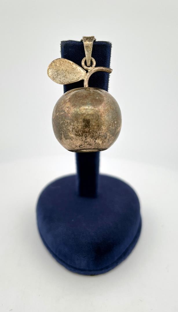Sterling Silver Apple Chiming Pendant: 1 3/8" long, 1" wide. Has a bell or chime inside.