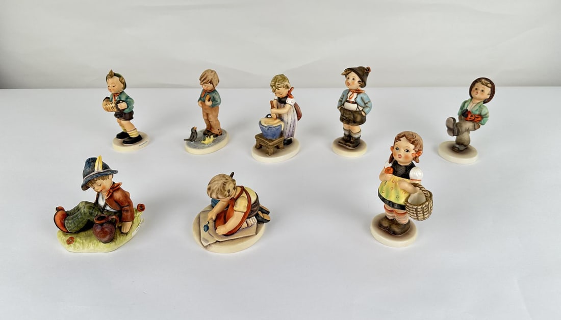 Collection of Goebel Hummel Figurines: 185 Accordion Boy, 300 Bird Watcher, 330 Baking Day, 95 Brother, 79 Trotter Hum, 409 Coffee Break, 309 Loving Greetings, 98 Sister.