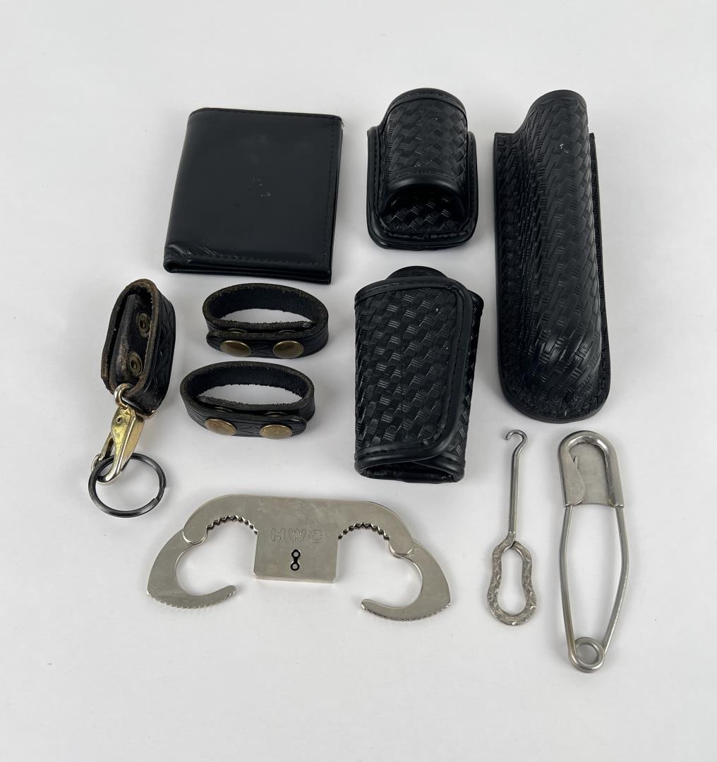 Group of Assorted Leather Police Items: Nice grouping including a set of thumb cuffs.
