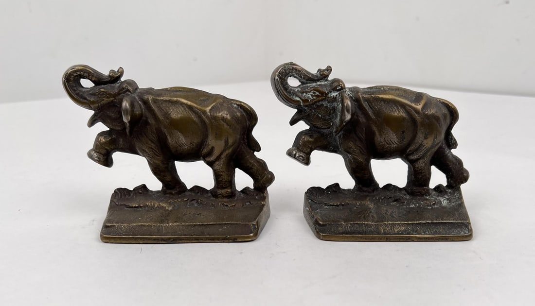 Cast Iron Elephant Bookends: Bases measure 4 1/2 by 1 3/4". They are 3 1/2" tall.