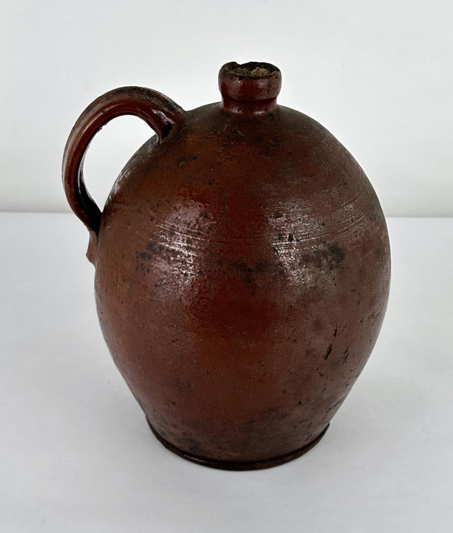 Antique Redware Ovoid Stoneware Handled Jug: 10 1/4" tall by 8" in diameter.